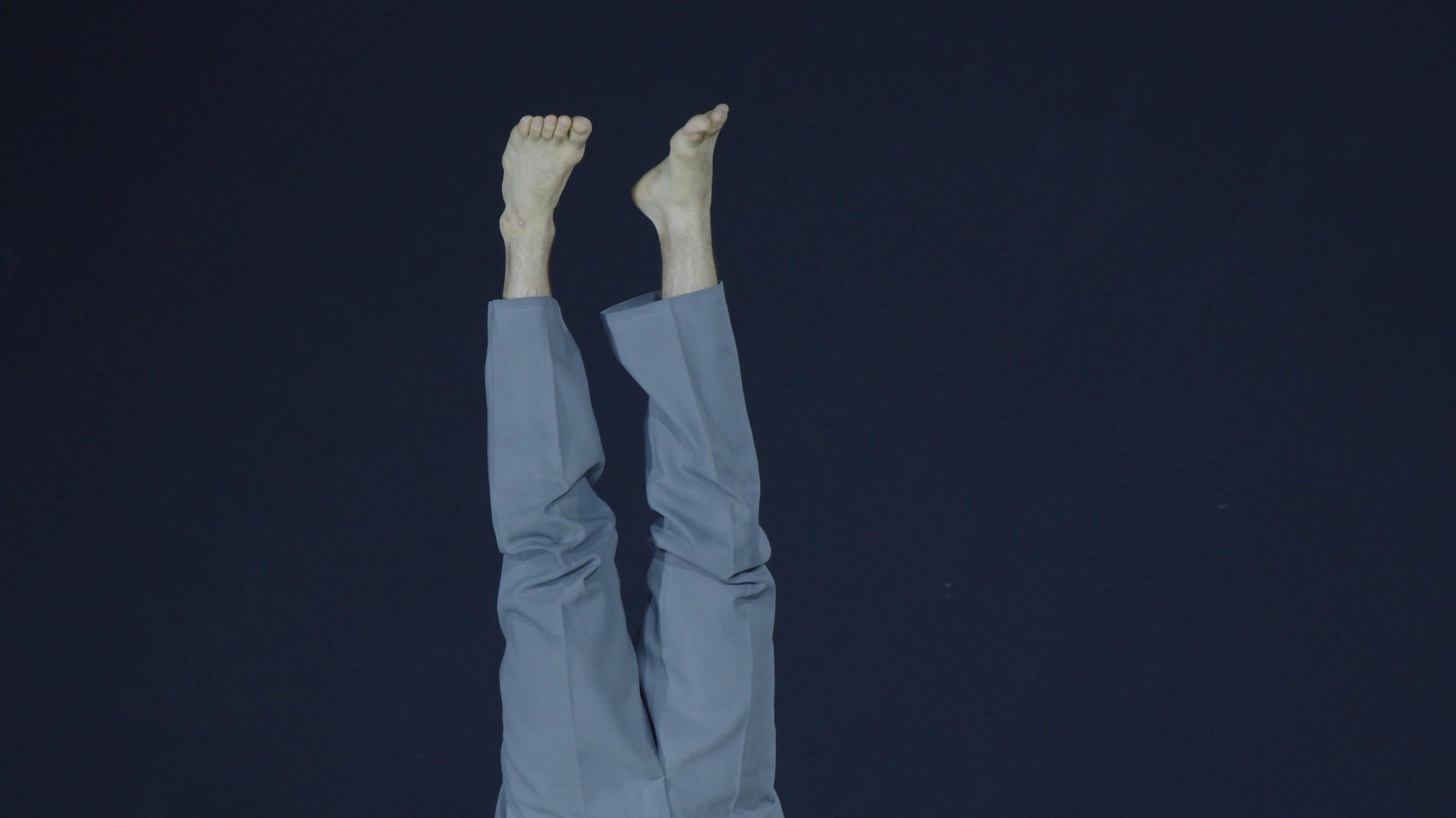 A dancers feet in the air while upside down